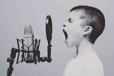 Boy Screaming into a Microphone